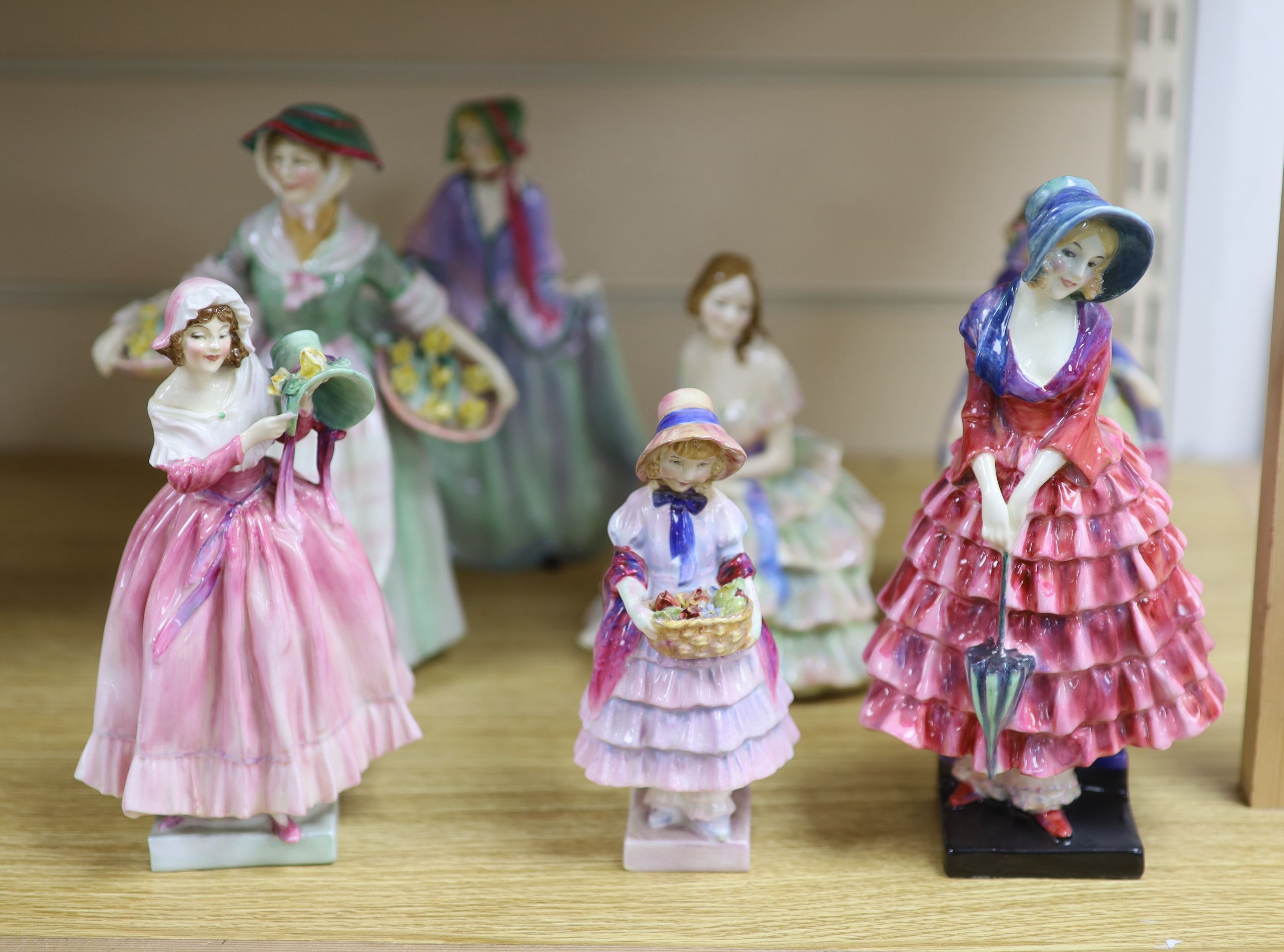 A collection of seven Royal Doulton figures: Priscilla HN1340, Daffy Down Dilly HN1712, The New Bonnet HN1728, Greta HN1485,